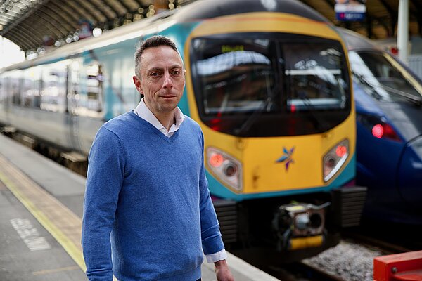 MIKE ROSS in front of a train 